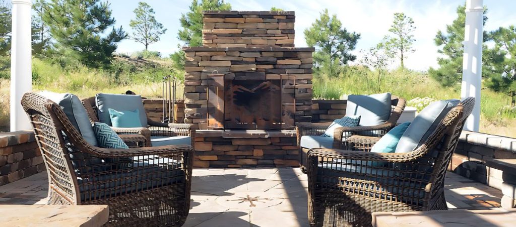 Image of a natural stone outdoor patio with fire feature and landscape design in Colorado Springs