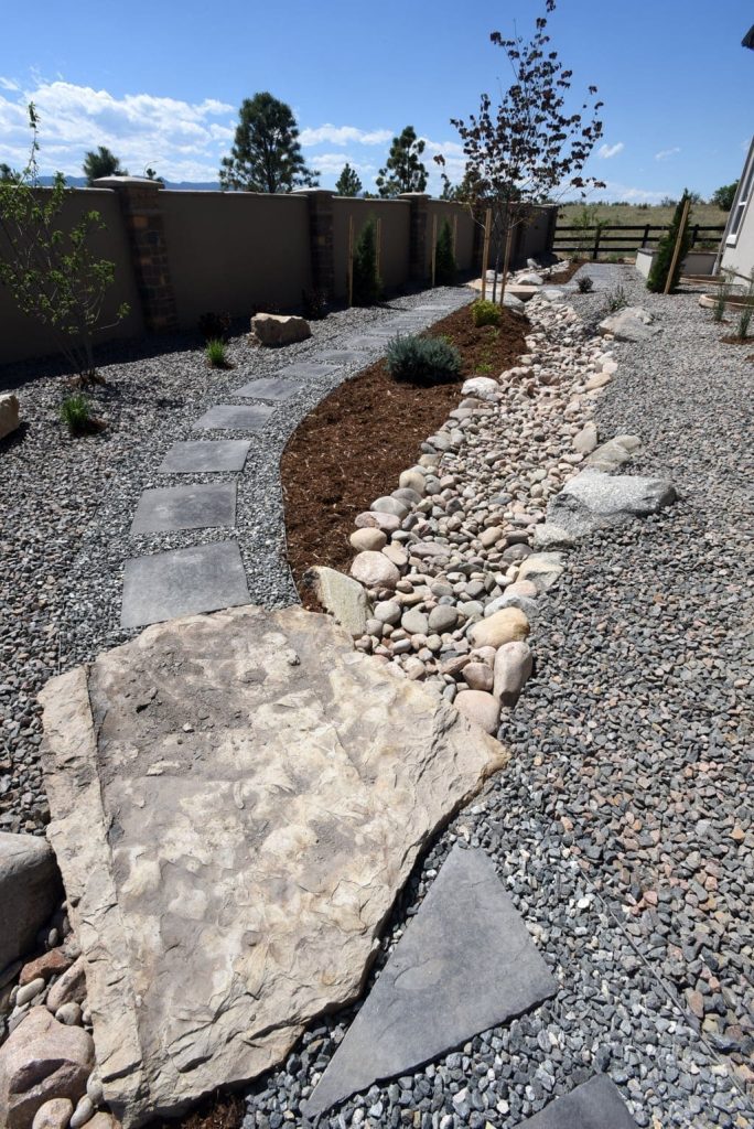 Image of a backyard transformation with custom hardscaping and landscape design in Colorado Springs
