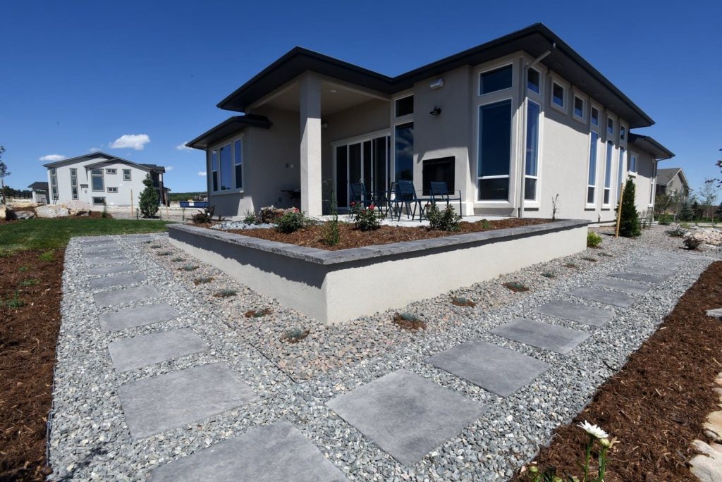 Backyard landscape design Image of a custom patio contractor project featuring natural stone surfaces in Colorado Springs