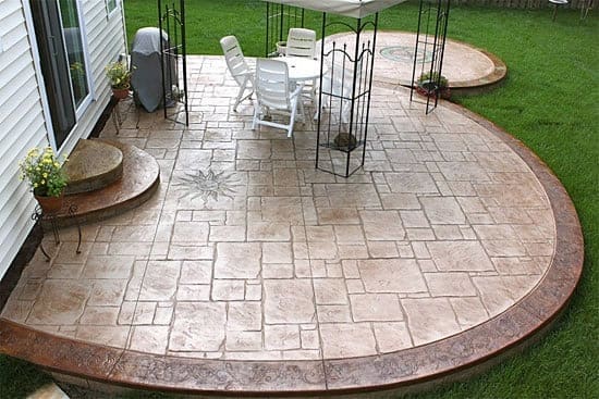 Image of a professionally designed backyard landscape with custom patio construction in Colorado Springs